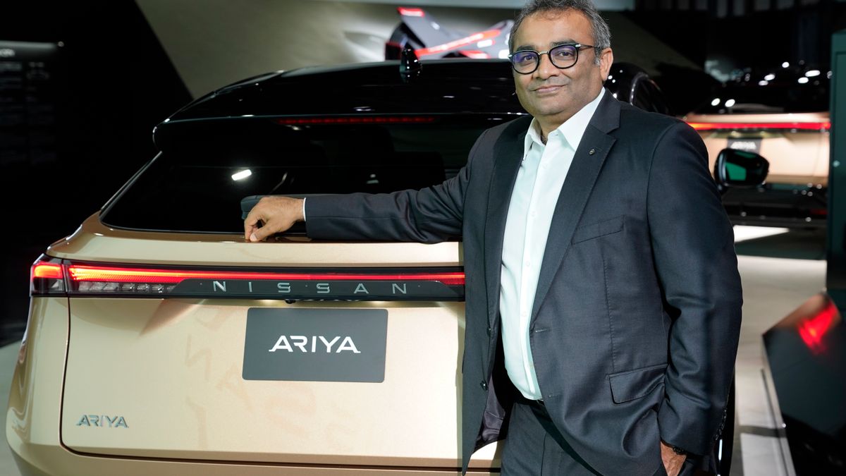 Nissan COO Ashwani Gupta pictured with the Airya electric SUV in July 2020.