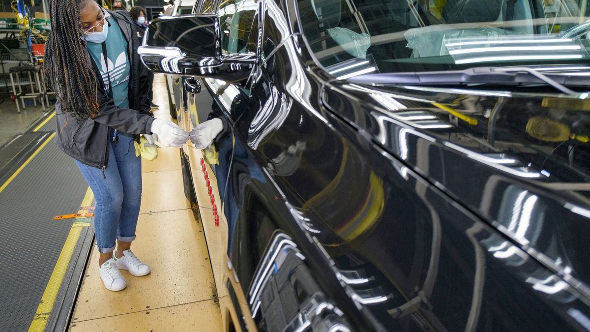 Autoworker inspecting a vehicle.