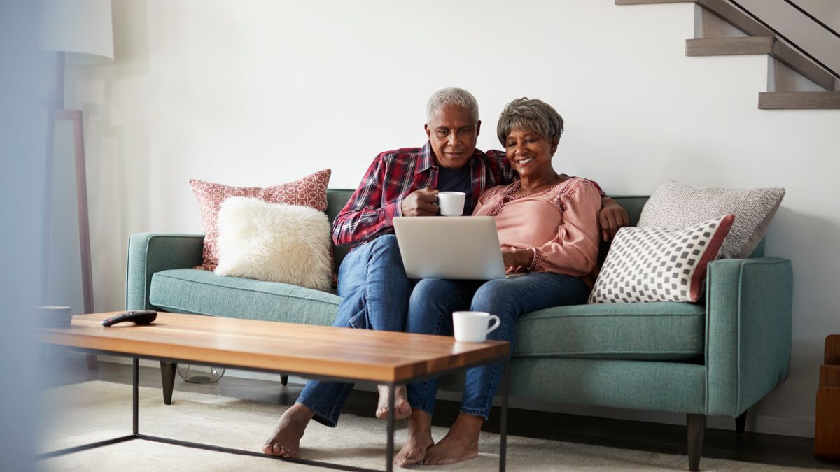 Two older adults shopping online together.